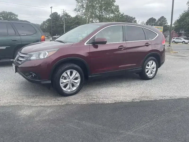 A red honda cr v is parked in a parking lot.