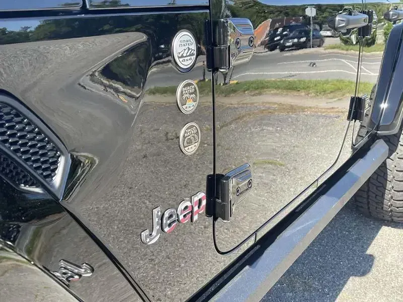 A black jeep is parked in a parking lot