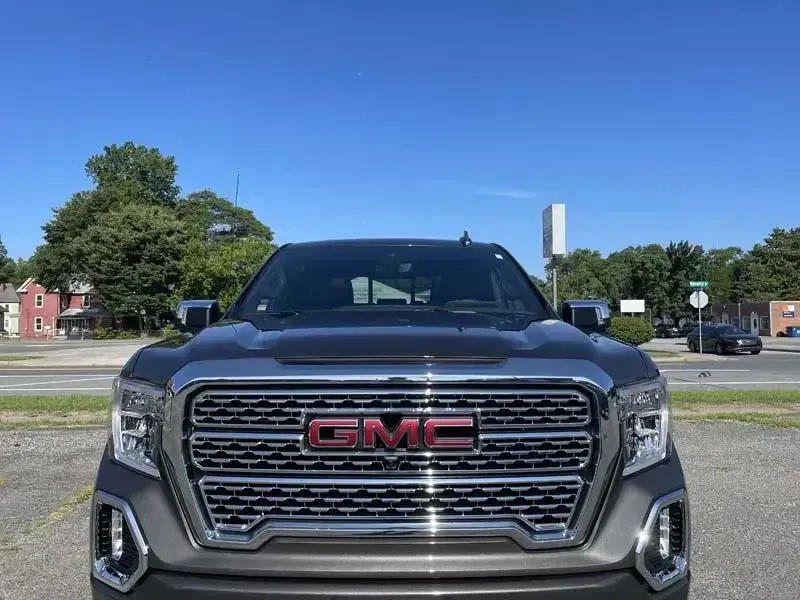 A gmc truck is parked on the side of the road.