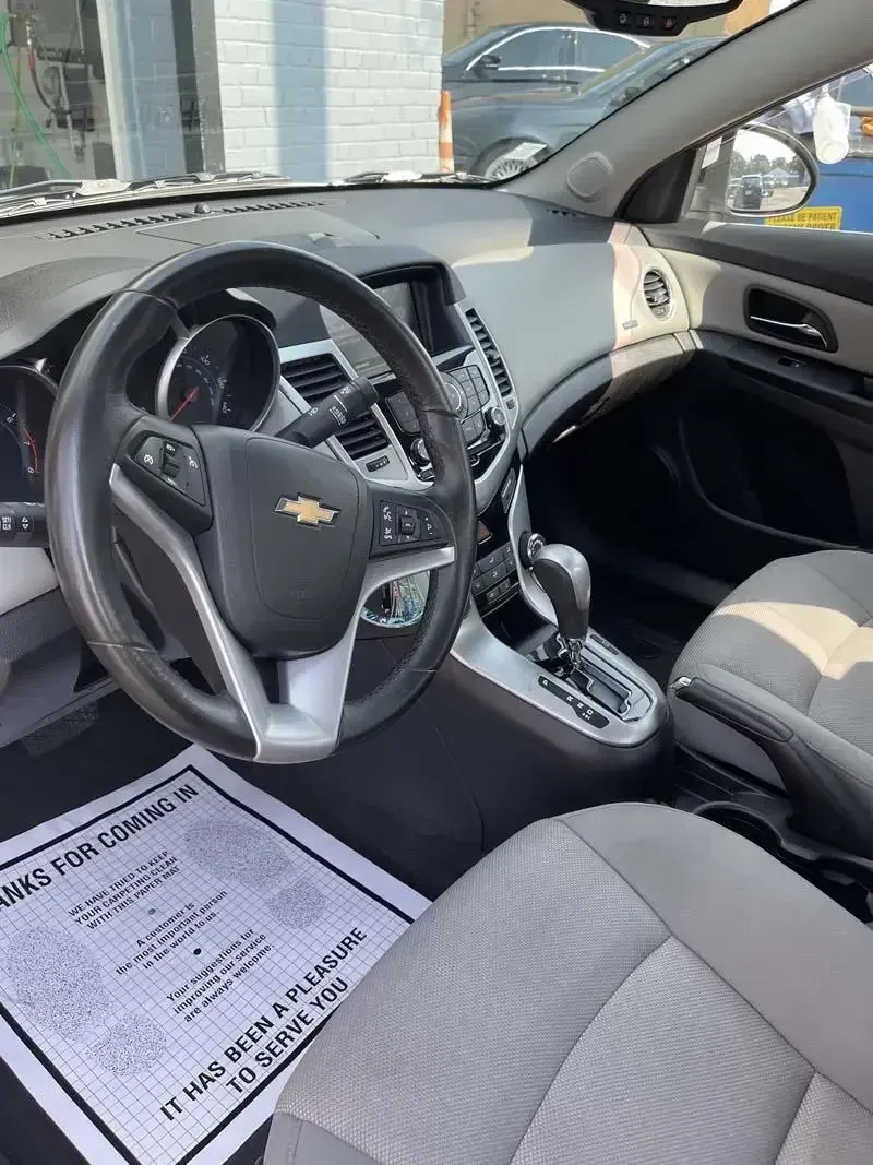 The interior of a chevrolet cruze with a steering wheel and seats.