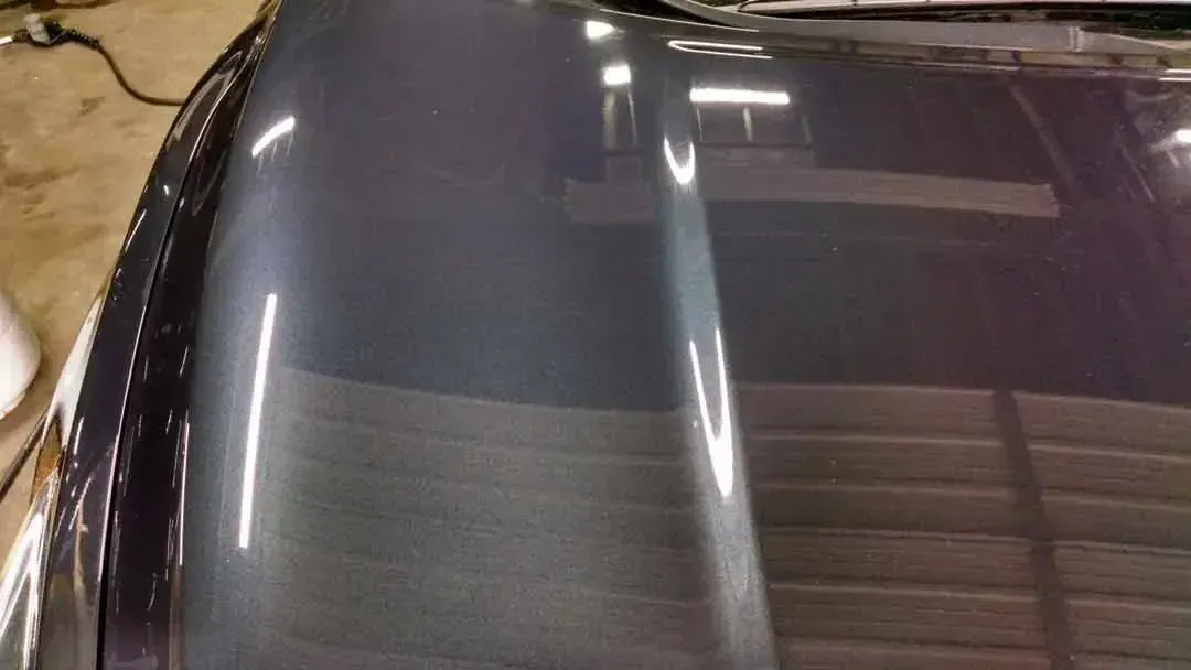 A close up of a car hood in a garage