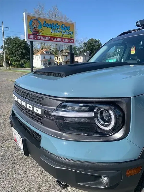 A ford bronco sport is parked in front of a car wash.