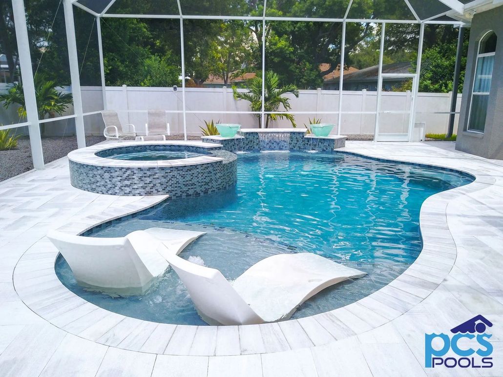 Pool with spa and lounge chairs inside, under a screened enclosure. Blue water, white accents.