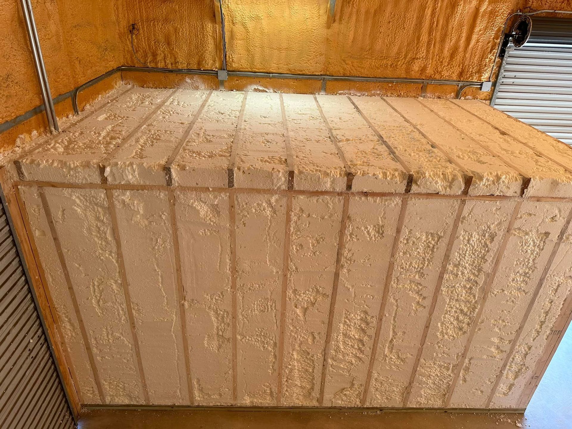 Foam insulation covers the interior walls and ceiling of a building.