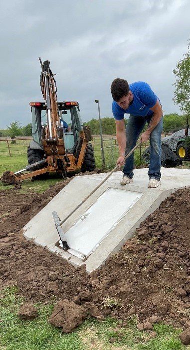 person constructing storm shelter