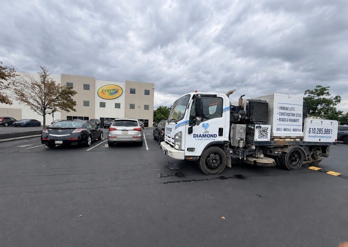  truck in a parking lot outside a building under cloudy skies