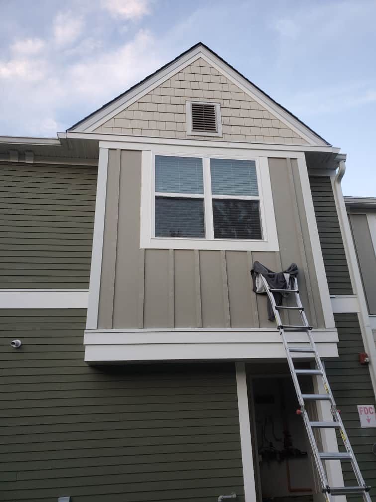 House exterior with a small gray bump-out addition and a ladder leaning against it