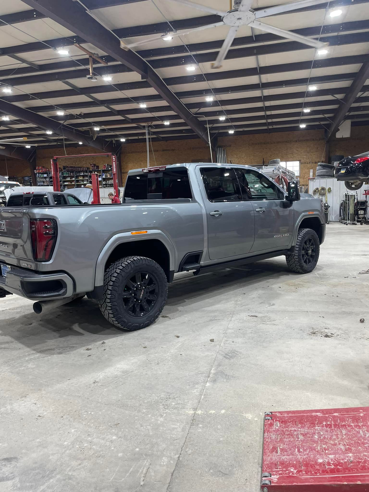 A gray truck is parked in a garage.