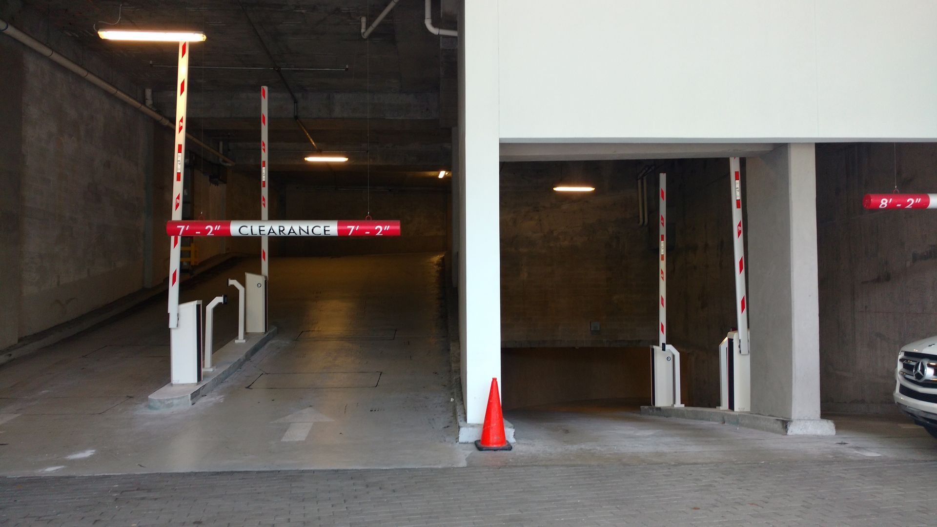 a white car is parked in a parking garage