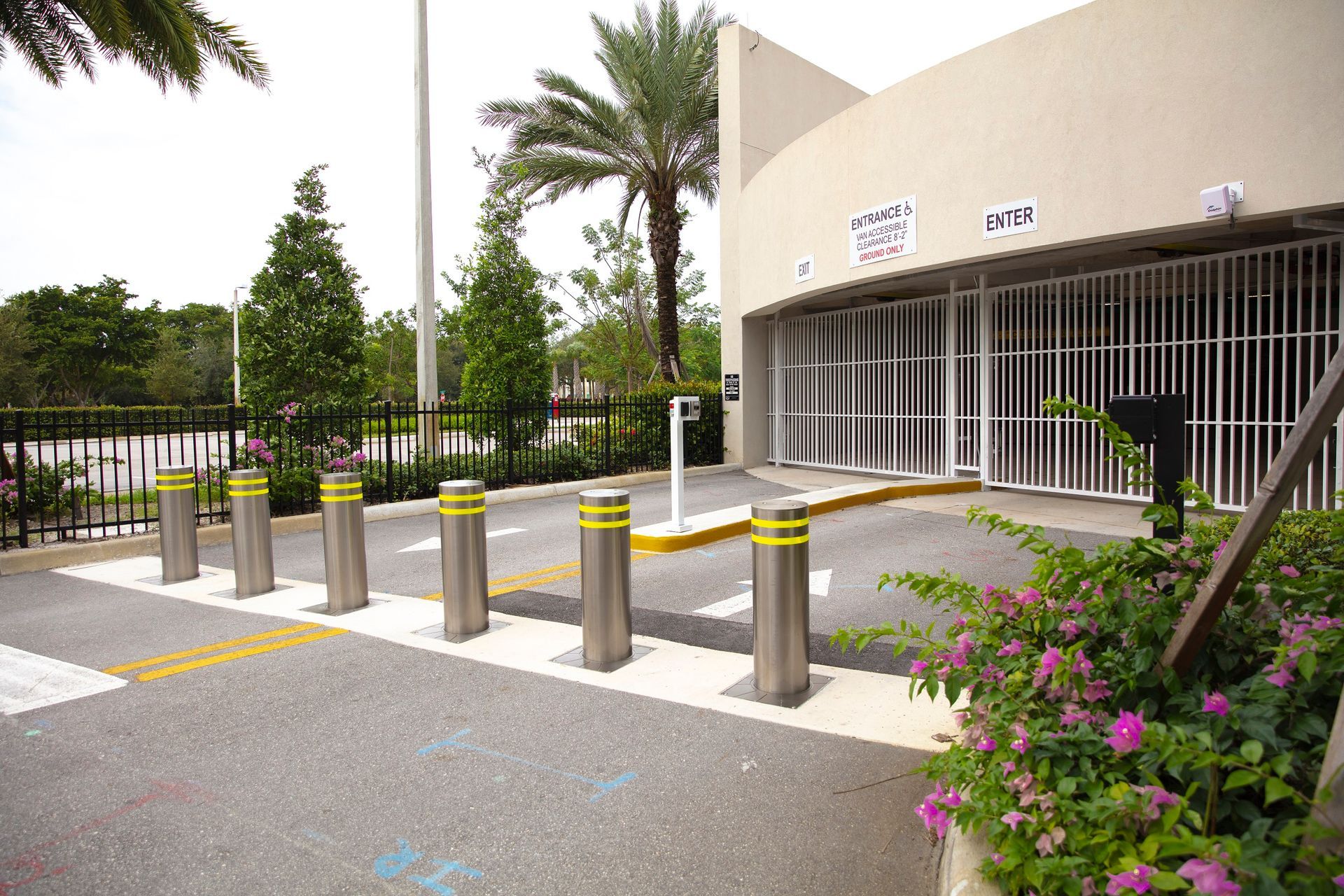 a row of stainless steel poles are lined up in front of a building .
