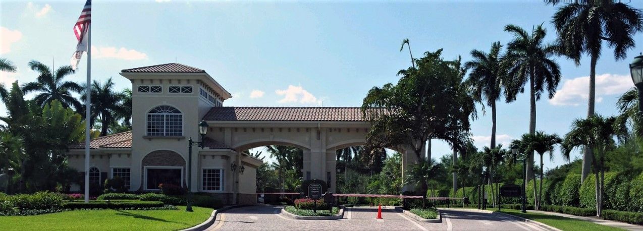 a large white building with palm trees in front of it .