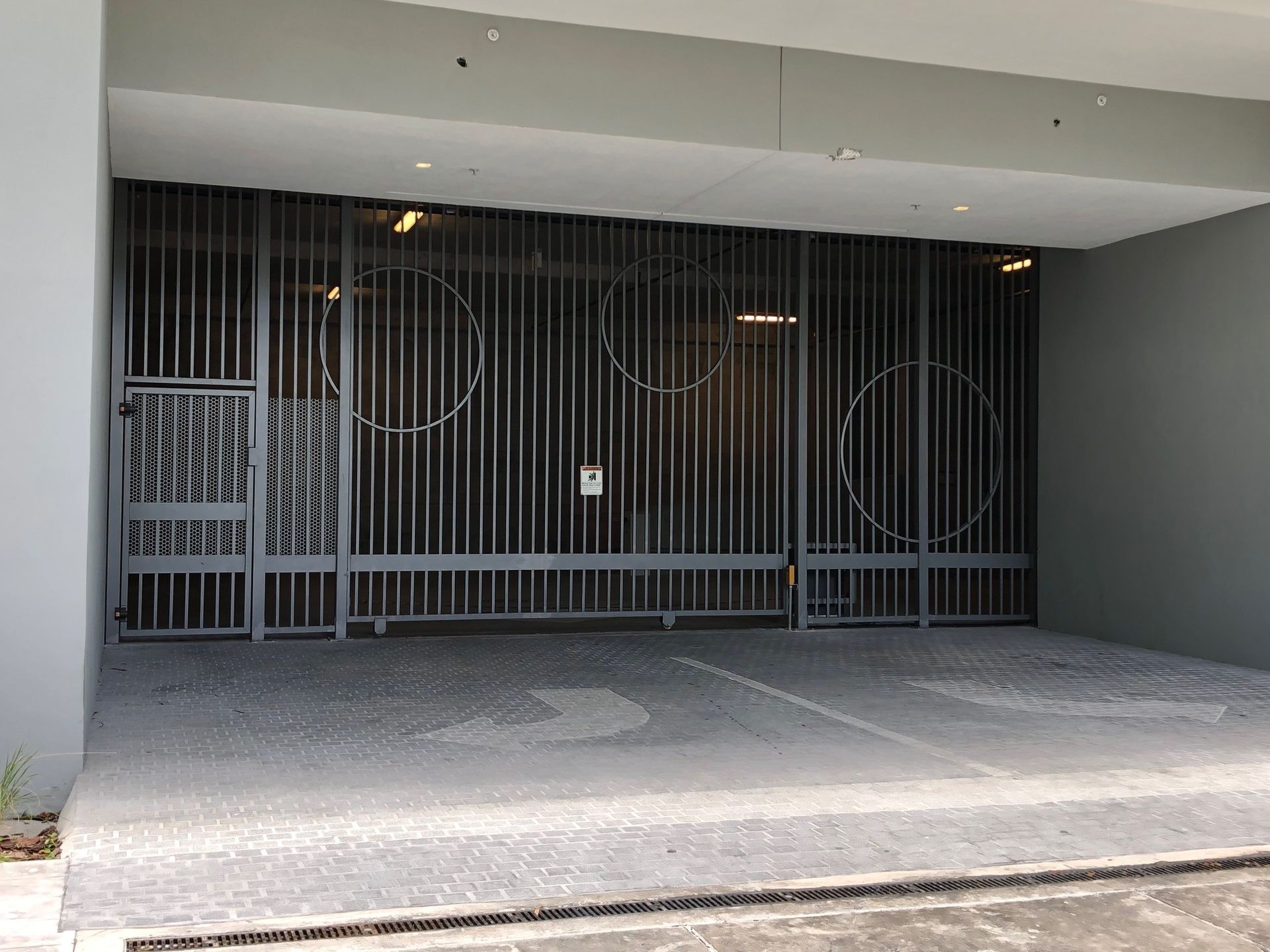 a parking garage with a fence and a sign that says no parking