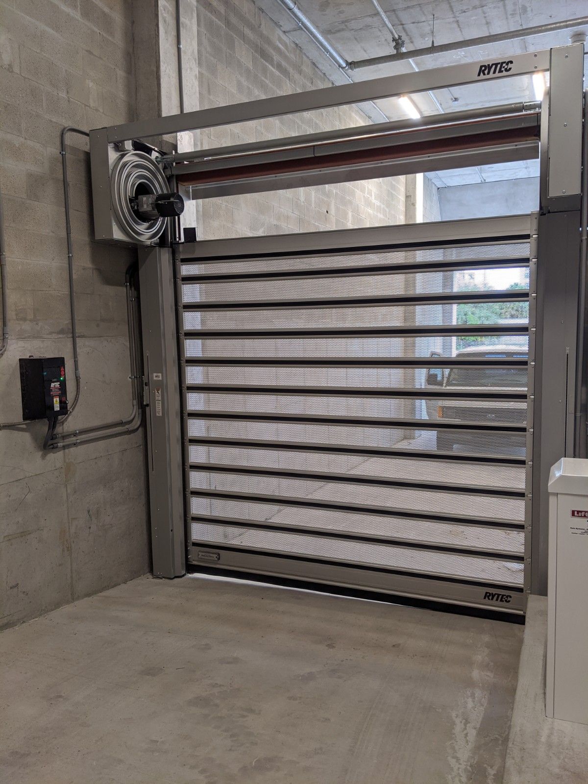 a stainless steel garage door is open in a garage .