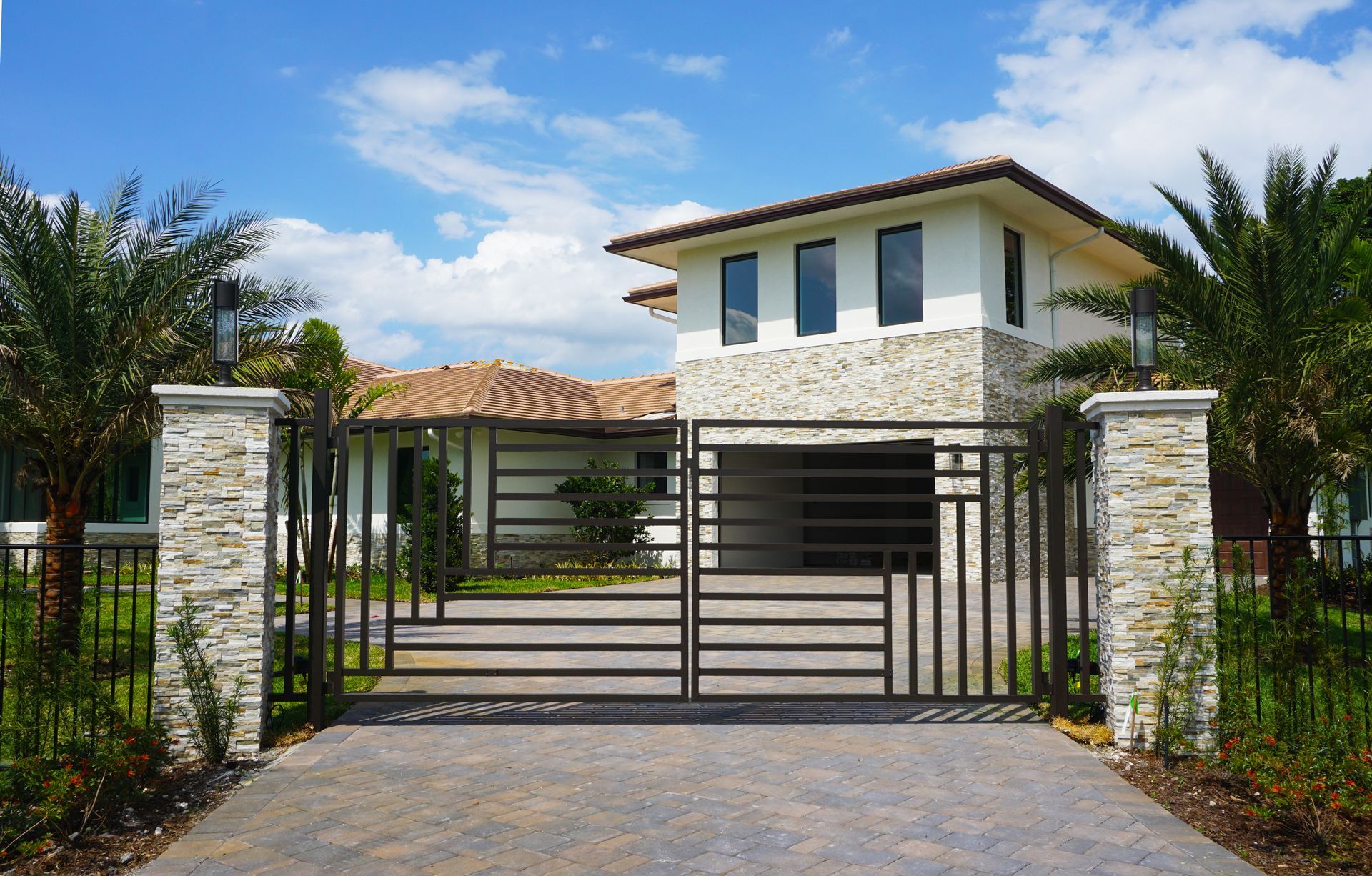 a large white house with a black gate in front of it .