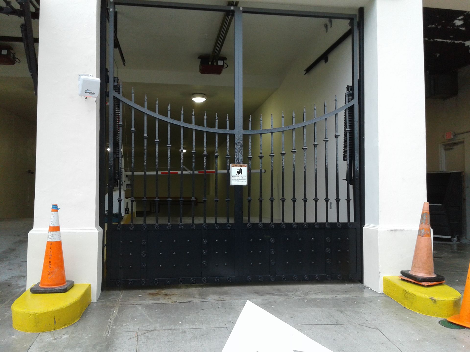 a black gate is open to a parking garage