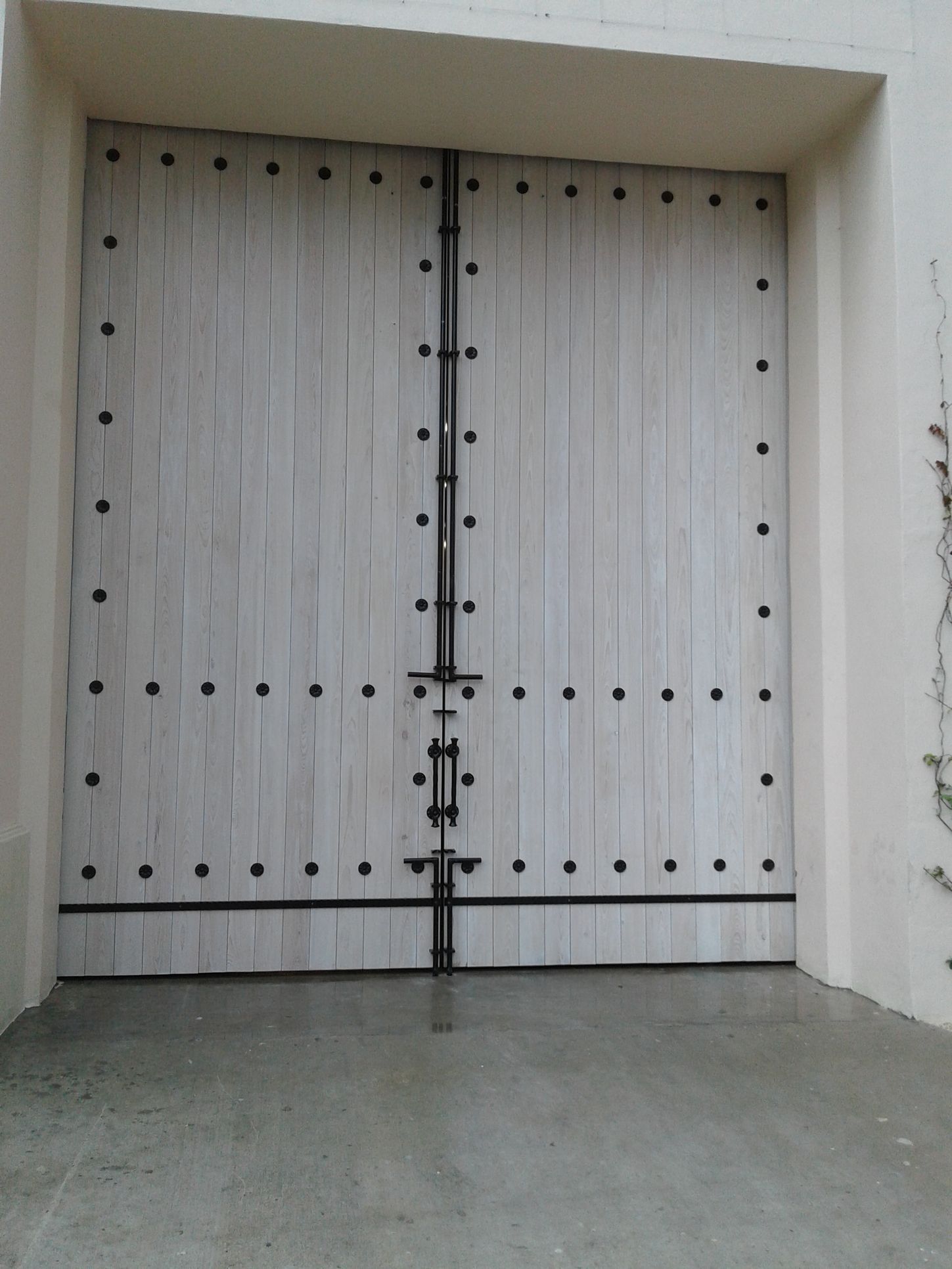 a white wooden door with black dots on it