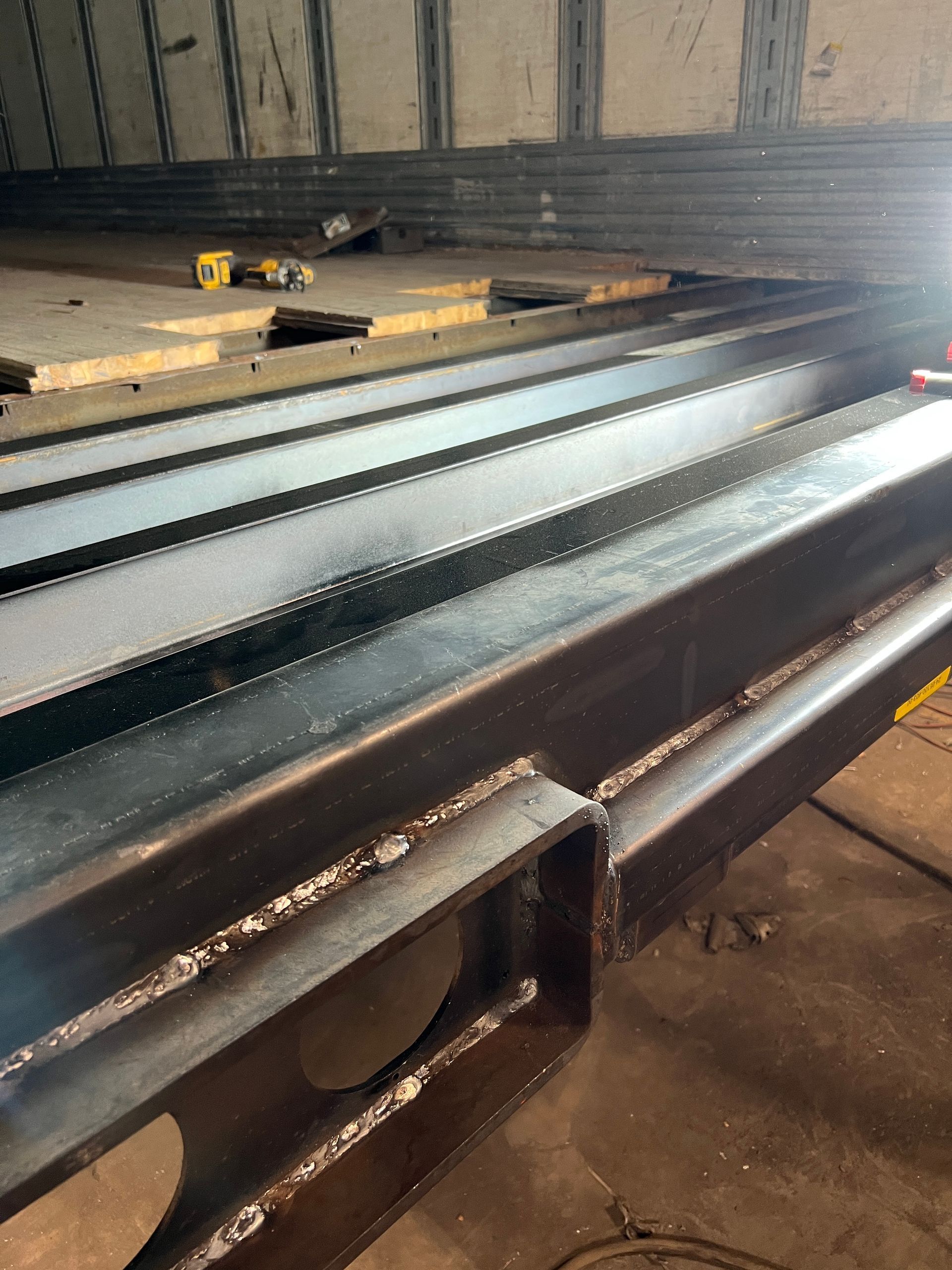 A bunch of metal pieces are sitting on top of each other in a room.