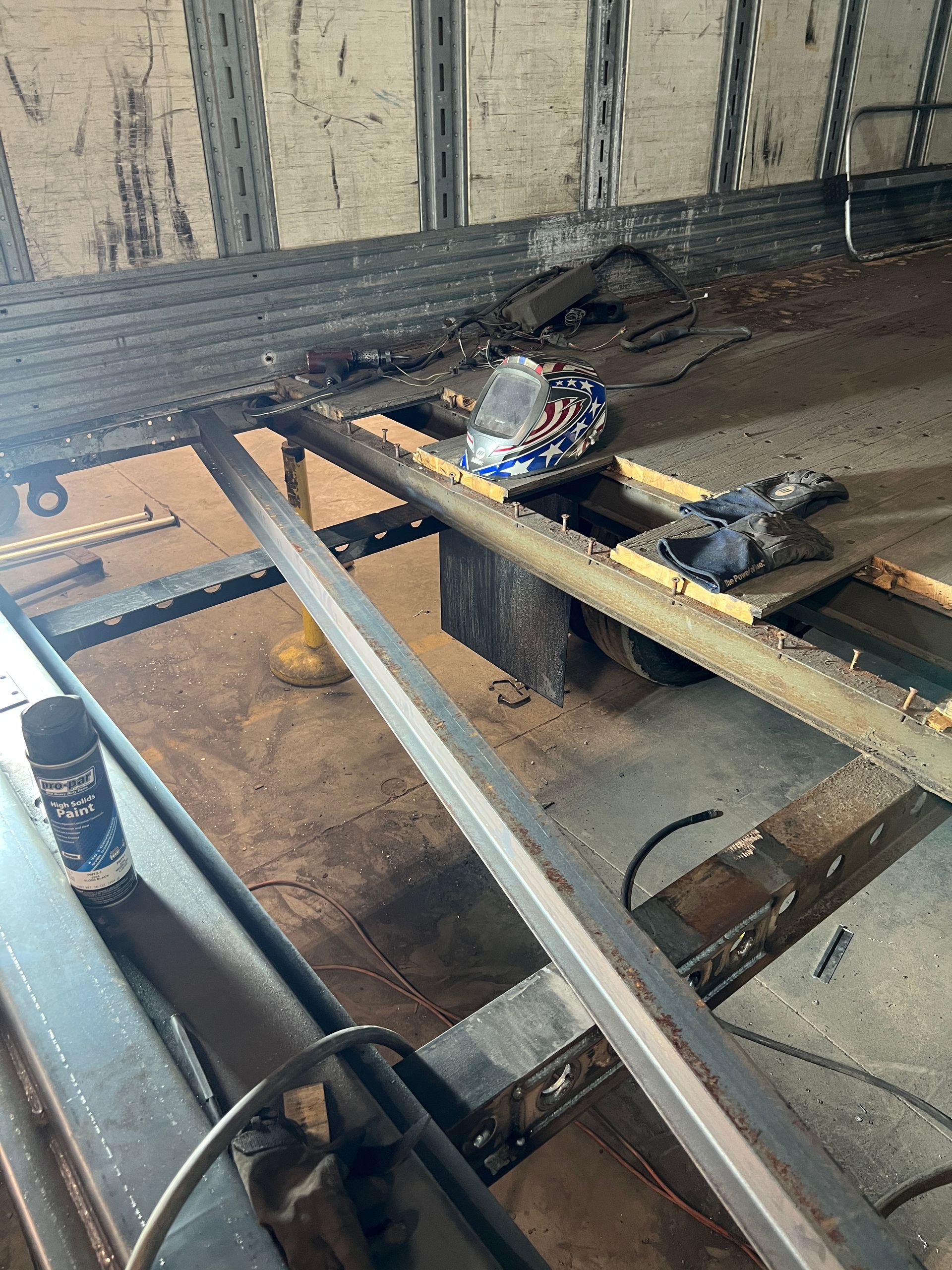A piece of metal is sitting on top of a wooden table.