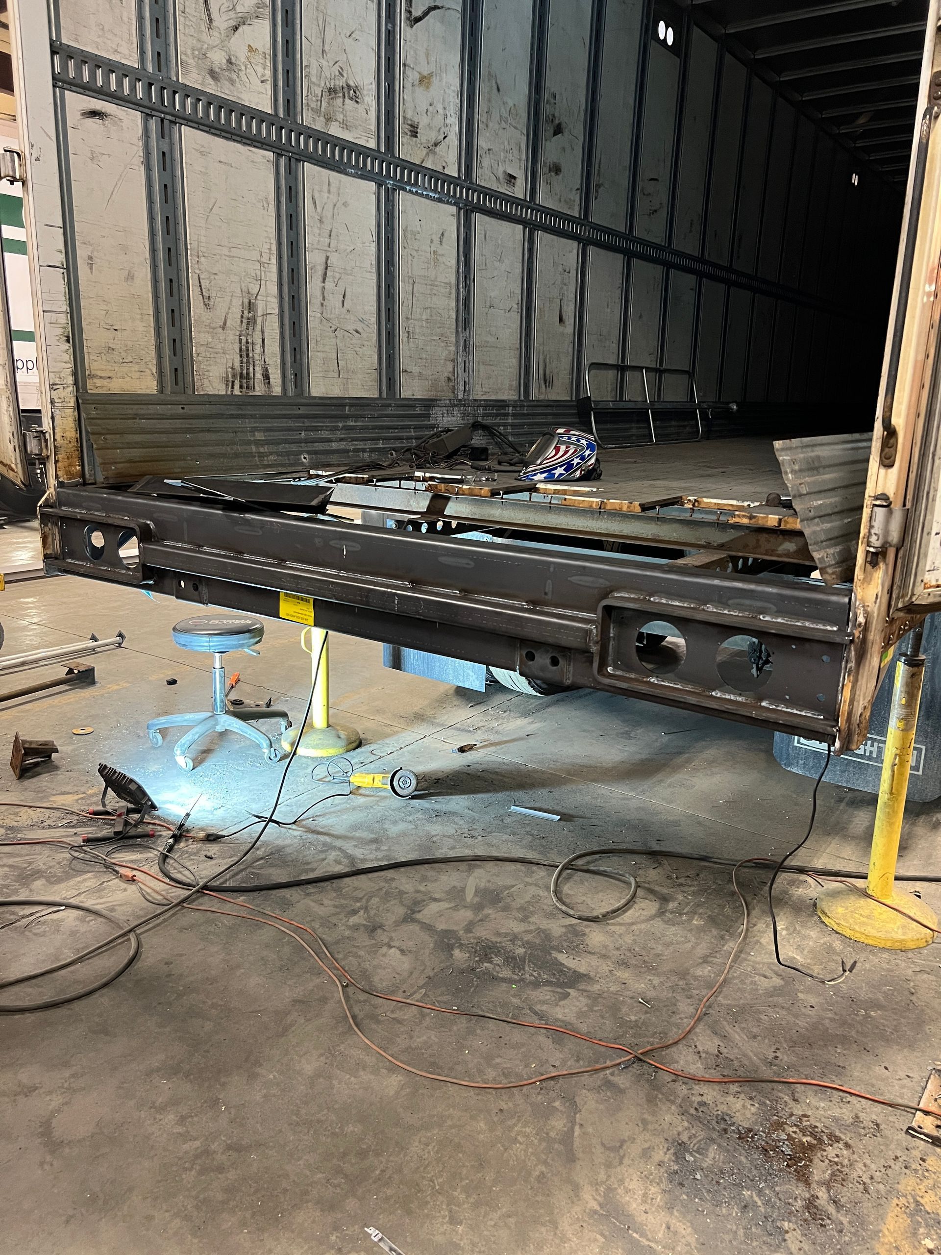 A truck is being repaired in a garage.