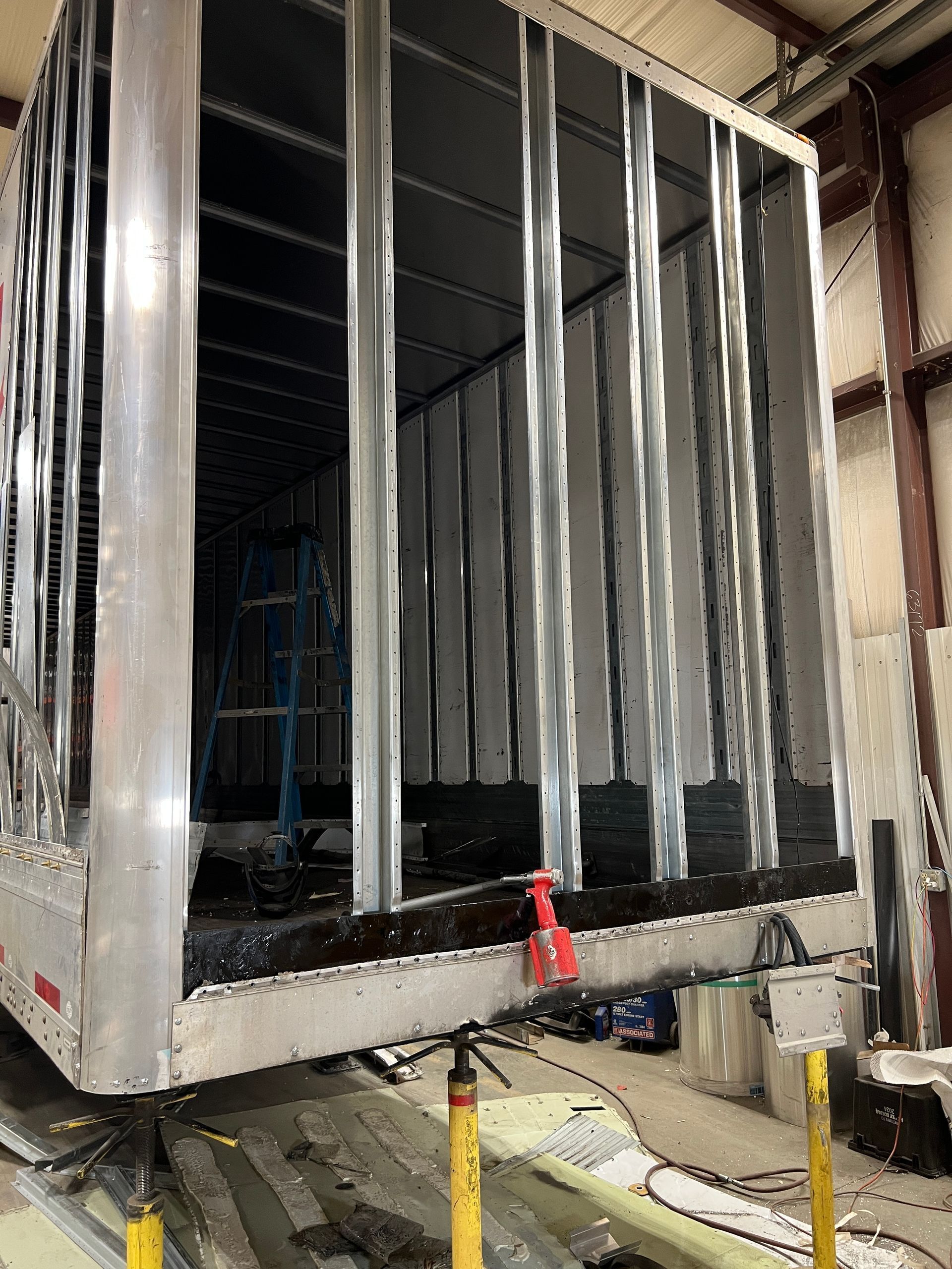 A large metal box is sitting on top of a wooden table in a building.