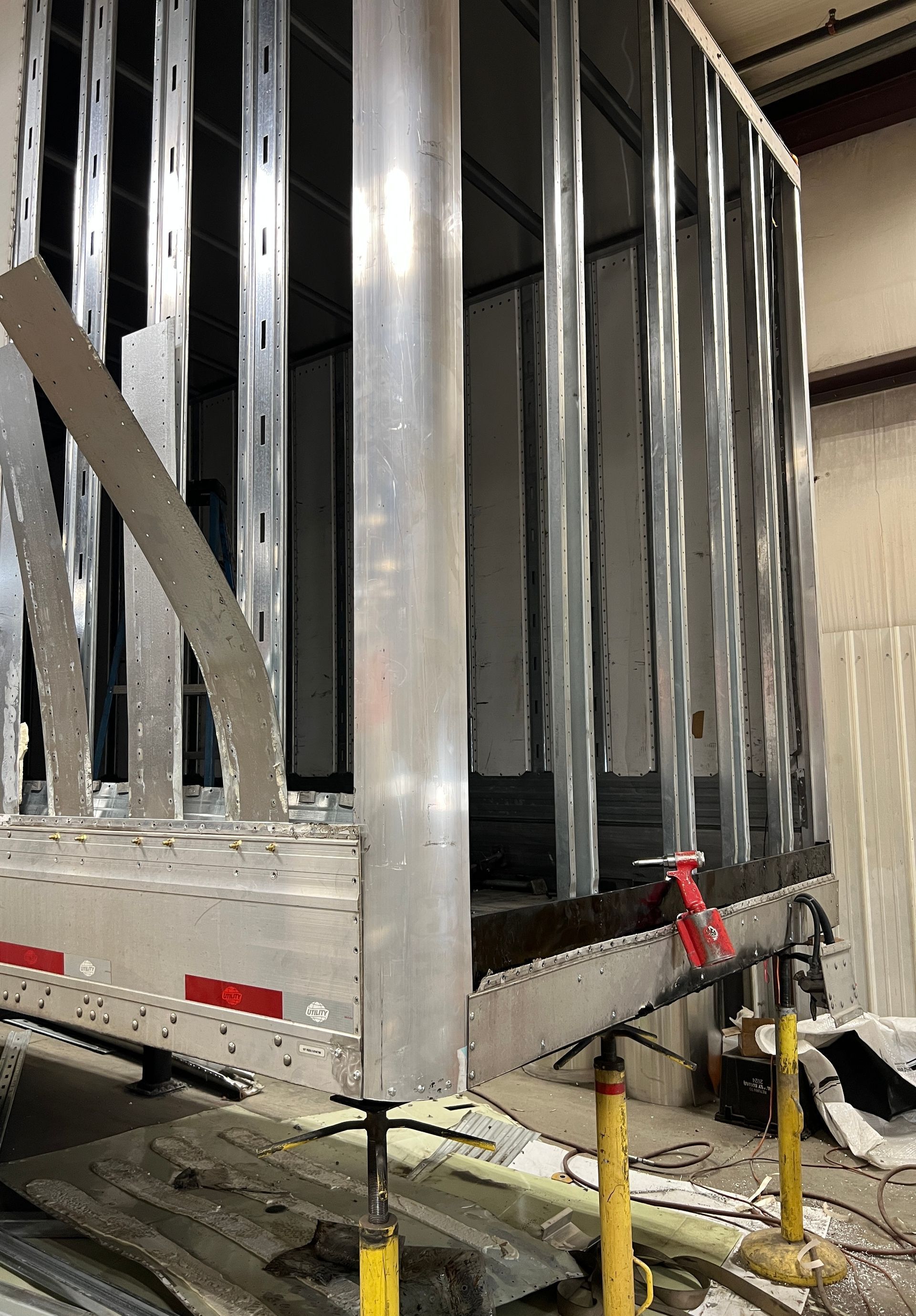 A metal structure is being built on top of a trailer.