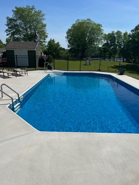 A large swimming pool with a fence around it