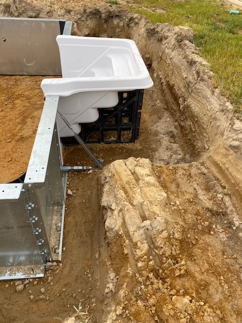 A swimming pool is being built in a hole in the ground.