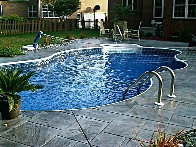 A large swimming pool with stairs leading to it