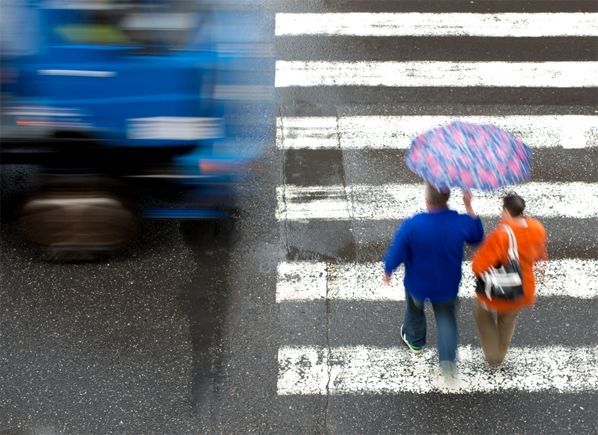 Pedestrians about to get hit by a fast moving vehicle