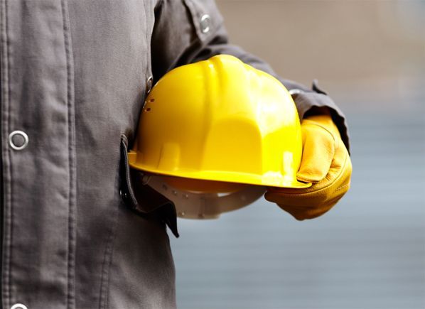 Construction worker holding a hard hat