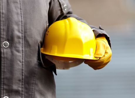 Construction worker holding a hard hat