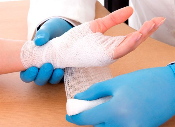 Medical gauze being applied on an injured hand