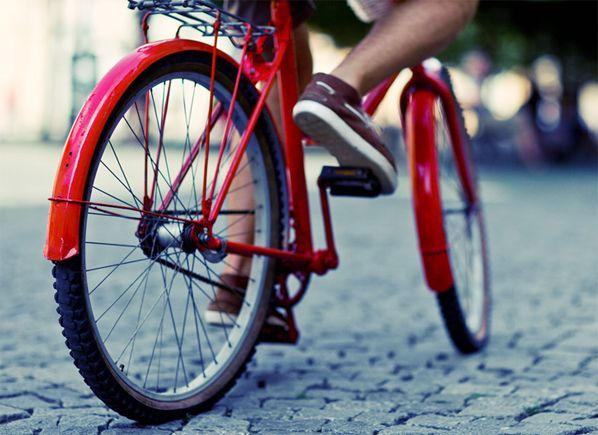 Man riding a red bicycle