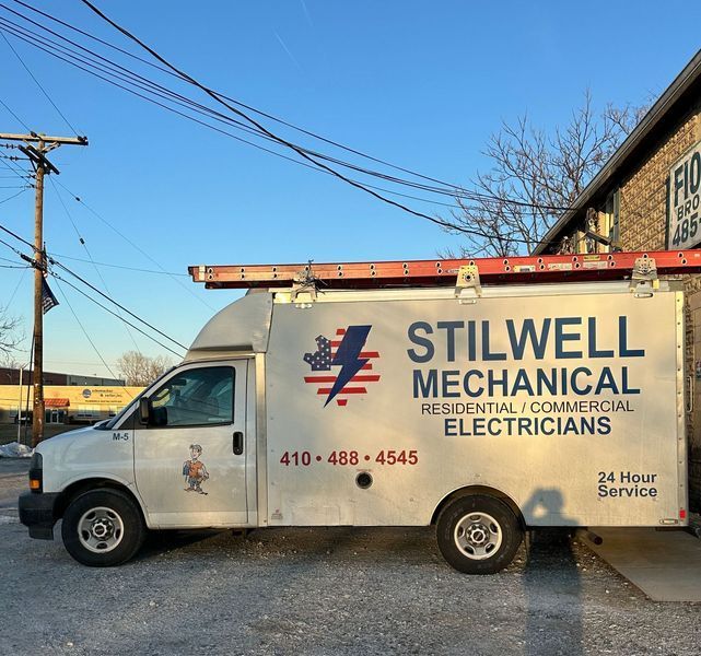 White Stilwell Mechanical service truck, 410-488-4545. Residential and commercial electricians. Ladder on top.