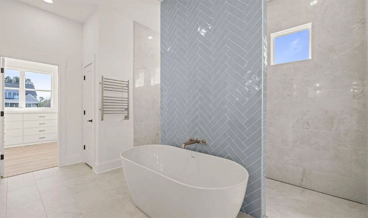 A bathroom with a bathtub and a shower