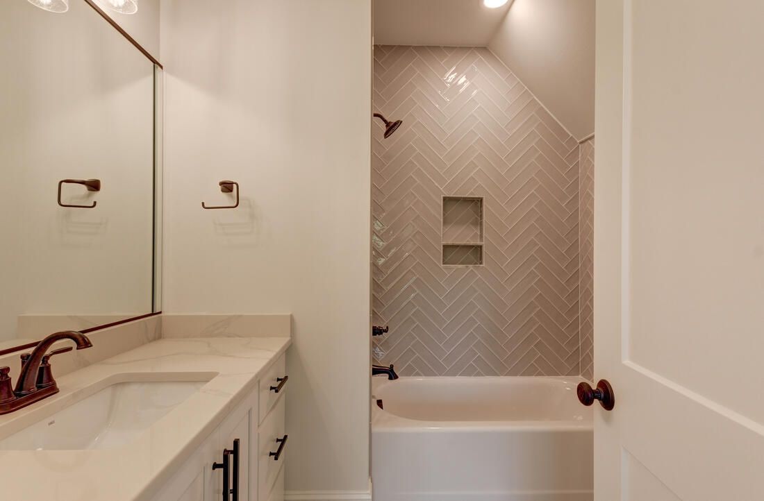 A bathroom with two sinks , a bathtub and a shower.
