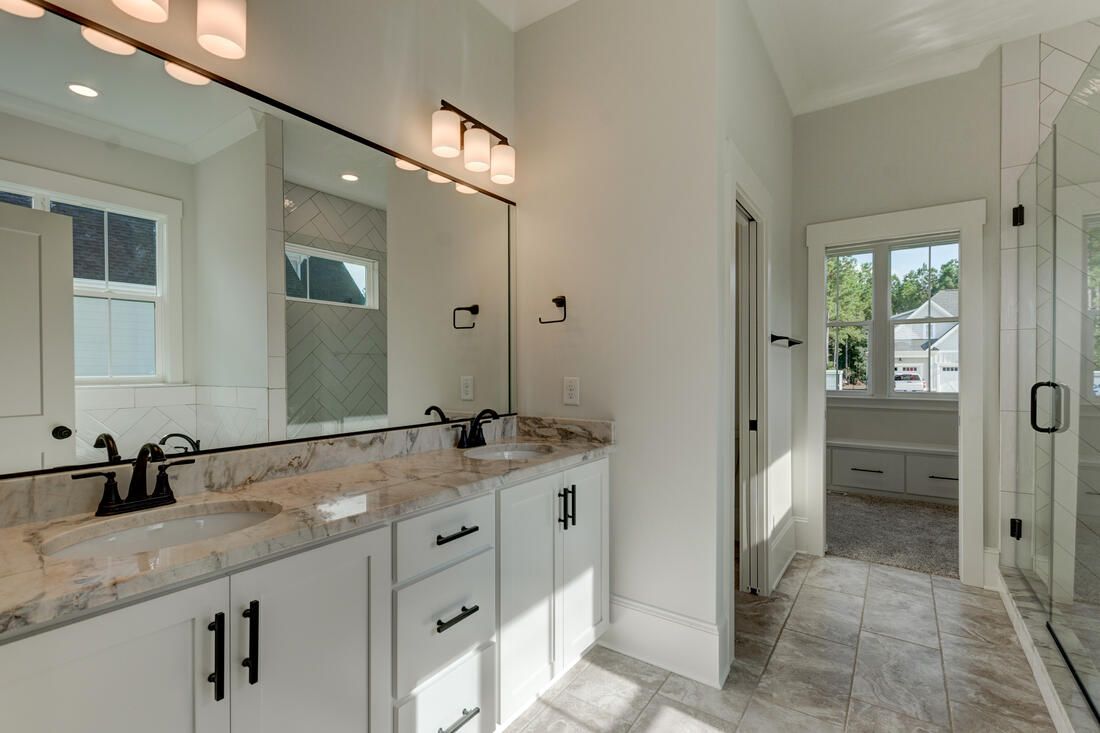 A bathroom with two sinks and a large mirror.