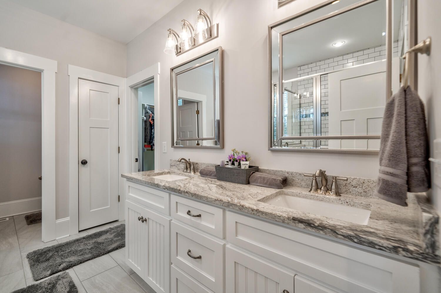 A bathroom with two sinks and two mirrors.