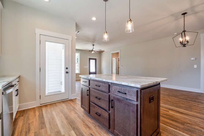 There is a large island in the middle of the kitchen.