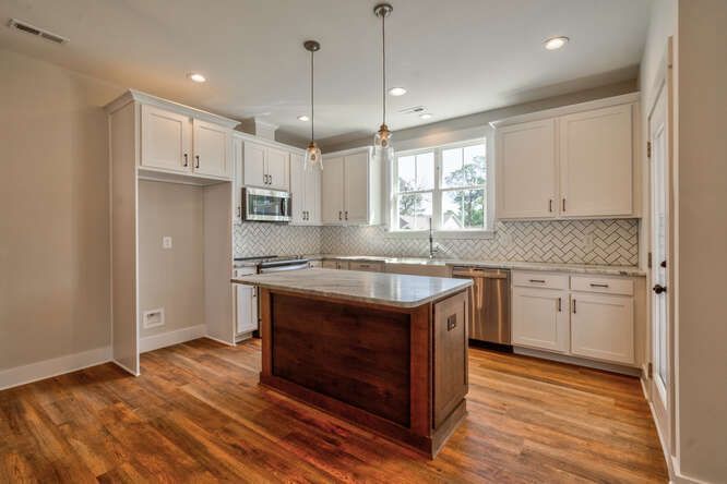 There is a large island in the middle of the kitchen.