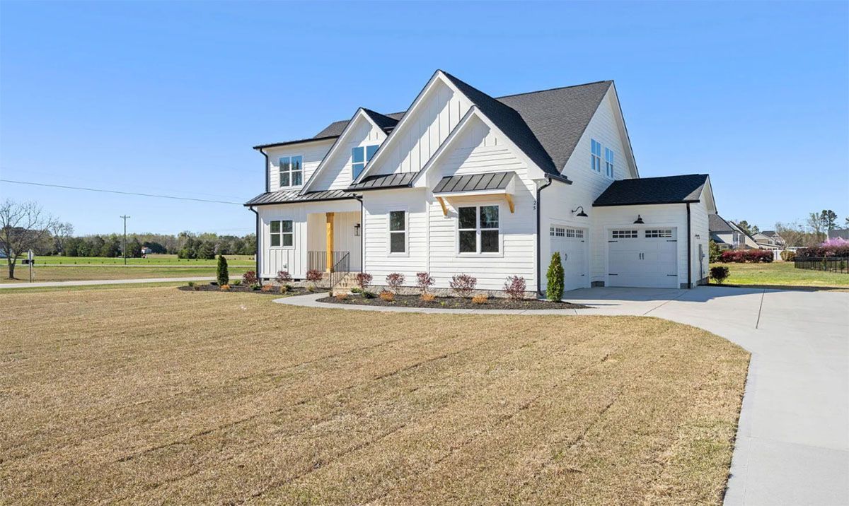 A large white house with a black roof