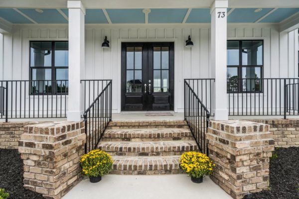 The front porch of a house with the number 75 on it