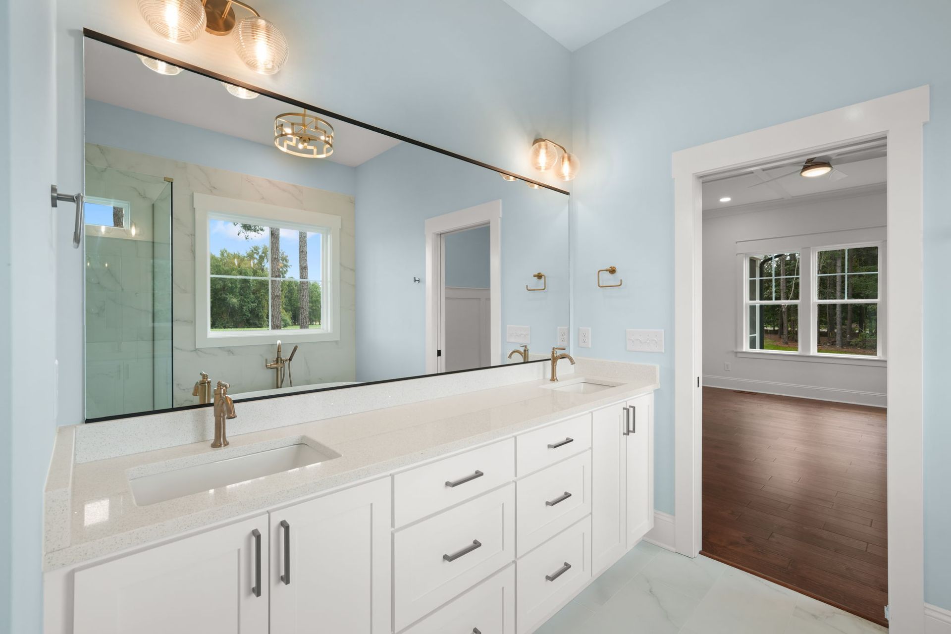 A bathroom with two sinks and a large mirror.