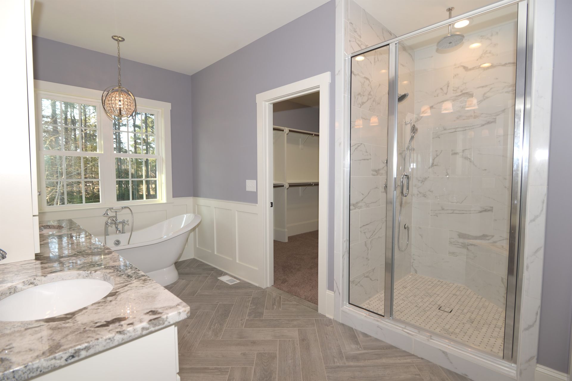 A bathroom with a tub , sink , and shower.