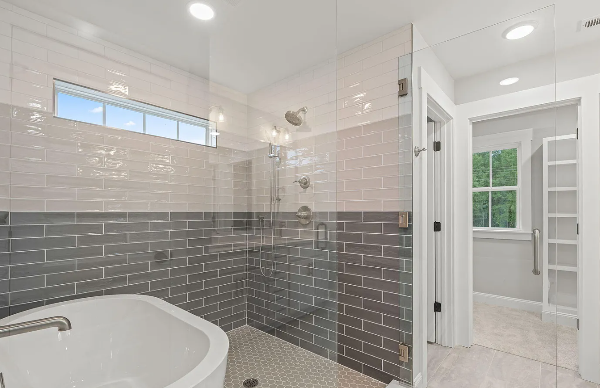 A bathroom with a tub and a walk in shower.