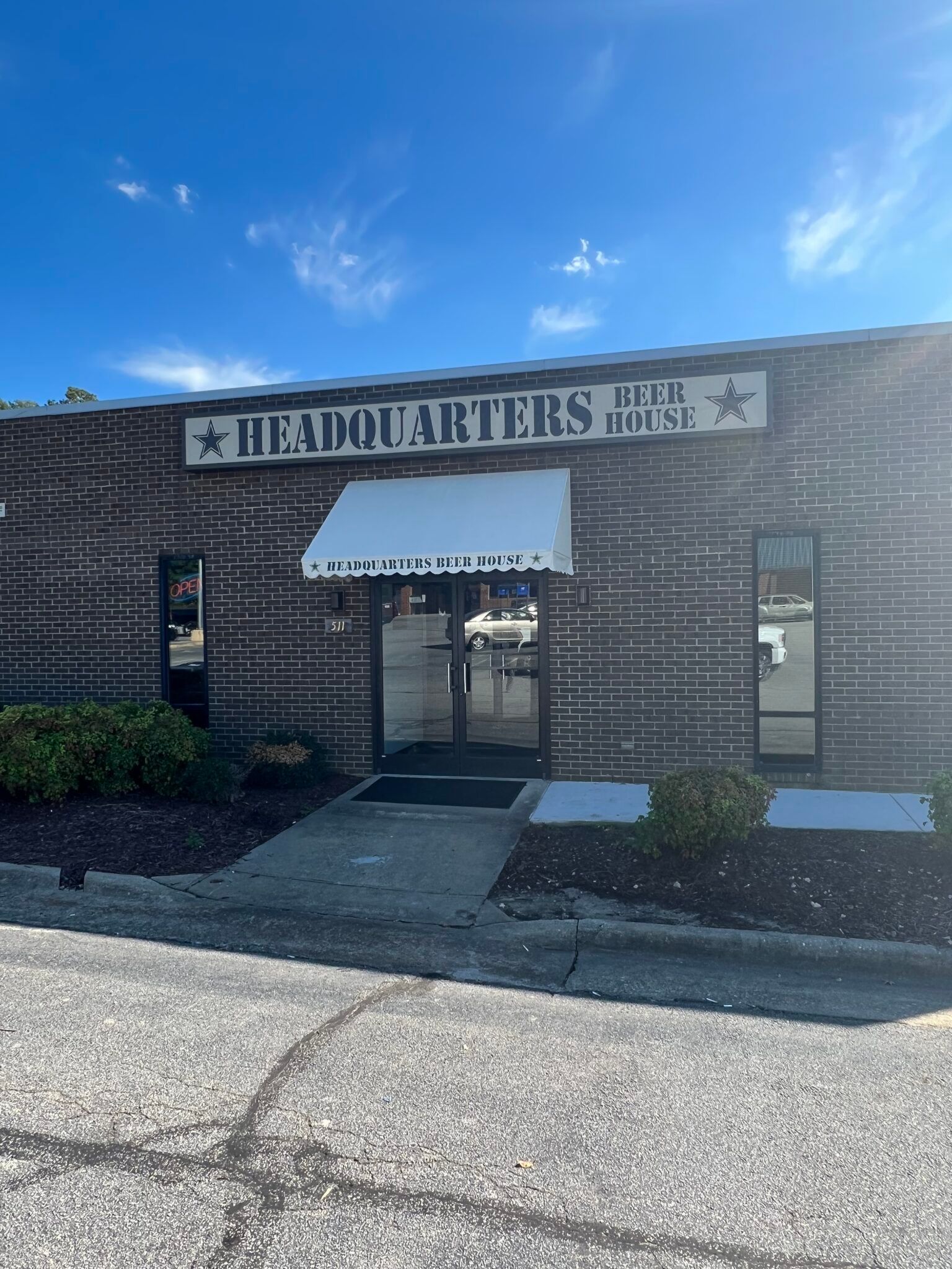 A brick building with a white awning on the front of it.