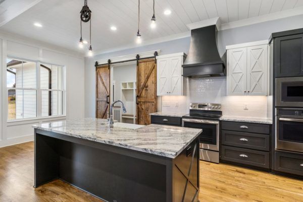 A kitchen with a large island and sliding barn doors.