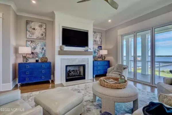 A living room with a fireplace and a flat screen tv