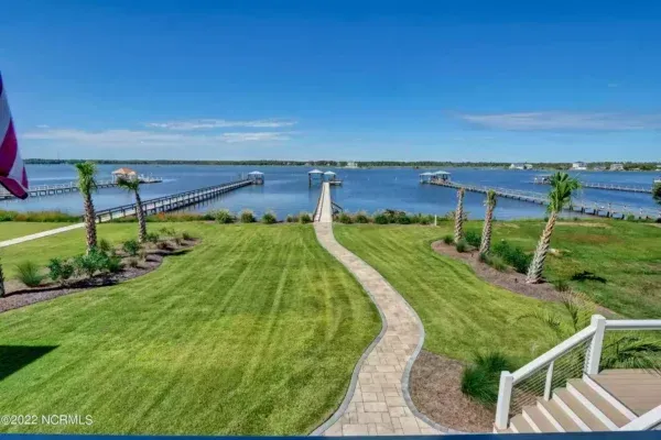 There is a walkway leading to the water and a dock.