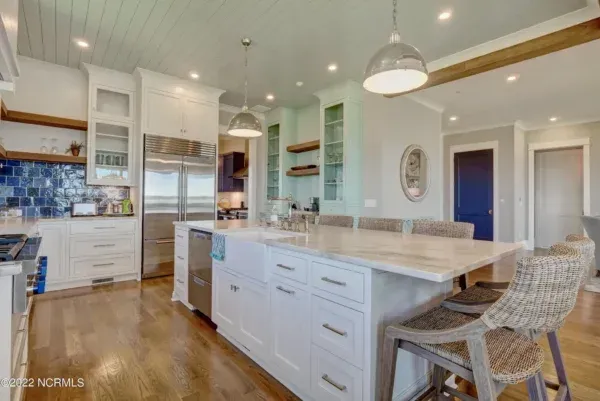 There is a large island in the middle of the kitchen.